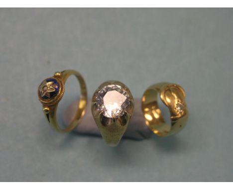 A 9ct. gold solitaire ring, set large clear stone, an 18ct. gold and enamel ring and an 18ct. gold buckle ring with inset sma