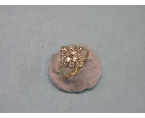 A diamond cluster ring, twelve diamonds, pave-set, unmarked yellow metal shank, size O/P