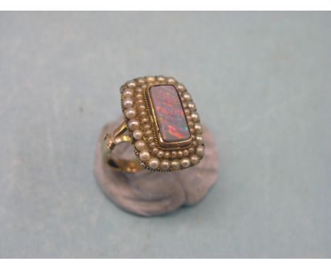 A Victorian 9ct. gold, black opal and seed-pearl dress ring, oblong cluster design