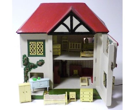 Small Tri-ang Doll's House, repainted with a red roof, green and yellow windows, foliage on the outside and a small front gar