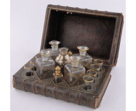 An early 20th century decanter box in the form of a pile of leather bound books,the interior fitted with 4 original glass dec