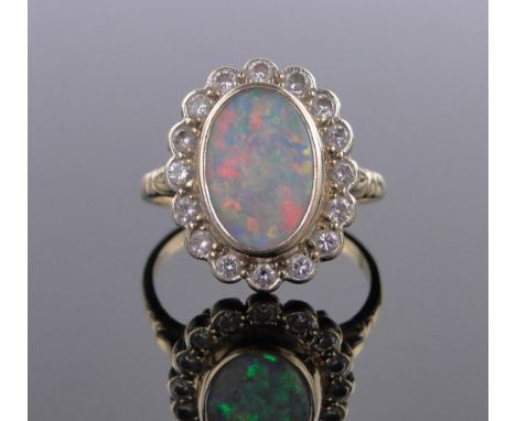 An 18 ct gold opal & diamond cluster ring,setting height 18 mm, size O