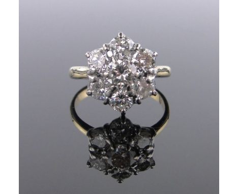 An 18 ct diamond cluster ring,setting height 14 mm, size O, modern round brilliant cut, colour approx J-K on average, clarity