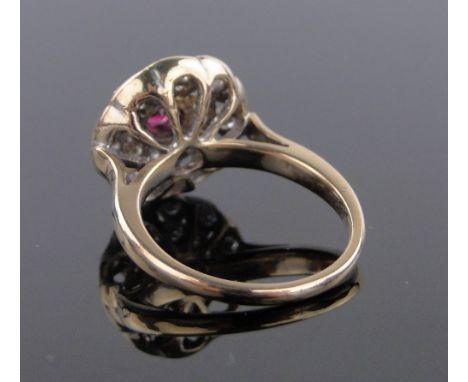 An 18 ct gold ruby & diamond circular panel ring,setting 15 mm across, size N