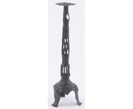 A Chinese patinated bronze candlestick,with pierced column & tripod base, height 14"