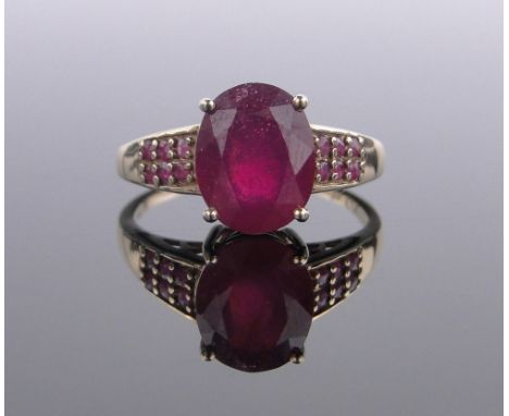 A 9 ct gold single stone ruby ring,with small ruby set shoulders, central stone height 10 mm, size S