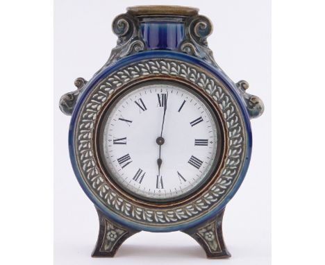 A Victorian Doulton Lambeth moon shaped mantel clock,by Ada Worthy 1882, with relief scroll mounts, 3.5" enamel dial, surmoun