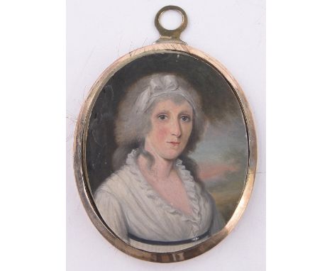 An early 19th century miniature watercolour on ivory,portrait of a woman, unmarked gilt metal frame, height excluding loop 2.