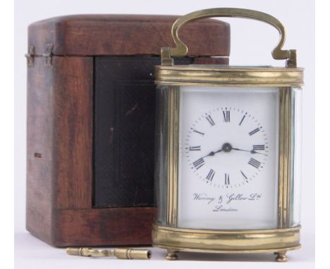 A French oval brass cased carriage clock,enamel dial, retailer Waring & Gillow, London, height excluding handle 4", original 