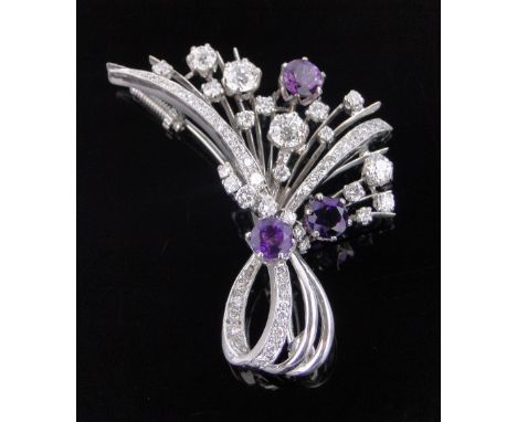 An 18 ct white gold diamond & amethyst set starburst design brooch c. 1950s,length 55 mm, set with approx 60 diamonds, old Eu