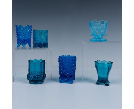 Stunning array of blue glass toothpick holders in a variety of shades and designs. Colors range from turquoise to deep blue. 