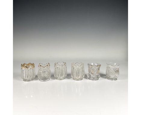 Set of six clear glass holders, featuring flower shaped openings, intricate glass cut designs and gilt edges. Elegant detaile