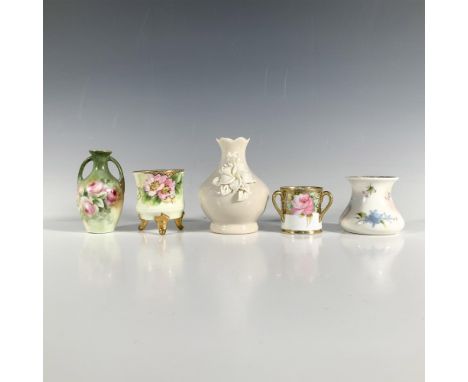 A captivating set of five miniature vases, including a cream-colored vase with a blooming white flower, a charming bouquet va
