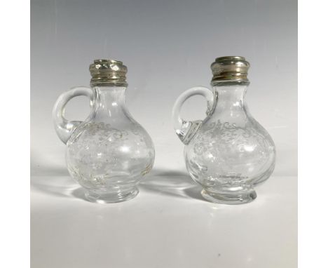 Handled salt and pepper shakers with a delicate Chantilly pattern etched into the glass. Each measures 2.25"L x 2"W x 3.25"H.