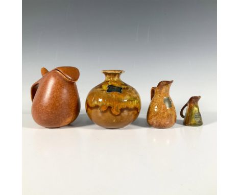 A terracotta pitcher with a lid, two miniature pitchers decorated with a tiger's eye style pattern, and a round vase with an 