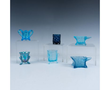 Six whimsical glass toothpick holders in various shades of blue. Two anvil-shaped holders are decorated in a daisy and button