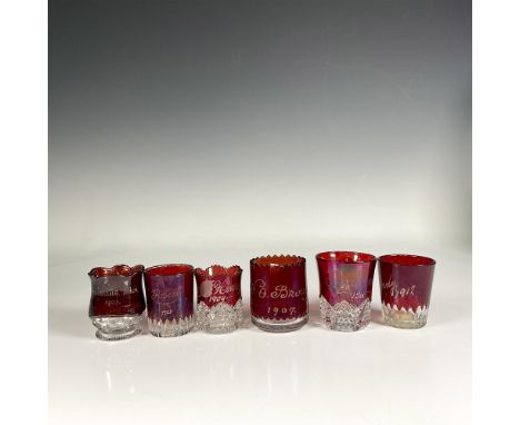 Set of six round red art glass toothpick holders, featuring mesmerizing clear glass accents on the bottom. Each has year in t