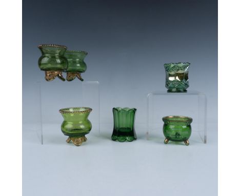 A delightful set of six dark green toothpick holders, all decorated with gold colored accents, that includes four shaped like