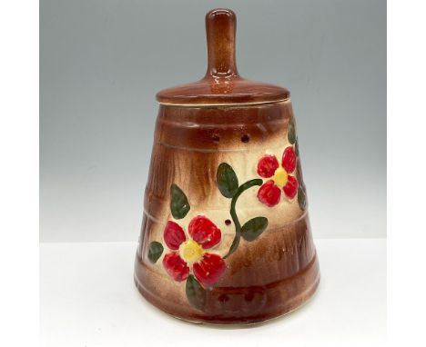 Churn styled cookie container, colored in natural brown with red flowers. Unmarked. Issued: c. 1930Dimensions: 11"H x 7.5" di