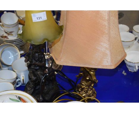 A bronzed resin figural table lamp withh frosted glass shade together with a further cherub based table lamp (2)