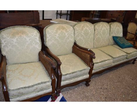 Early 20th Century Bergere three seater sofa and matching pair of armchairs, cane work requiring repair in several areas, lar