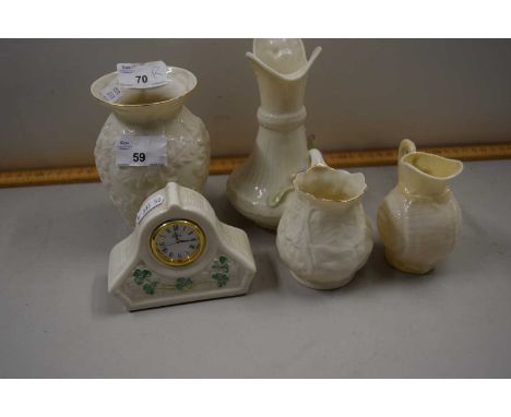 Collection of Belleek porcelain wares comprising three jugs, a mantel clock and vase
