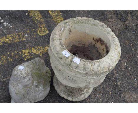 Buddha model and a concrete urn