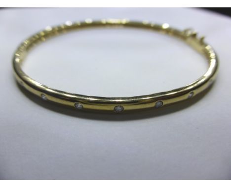 A 9ct gold and diamond bangle, 
