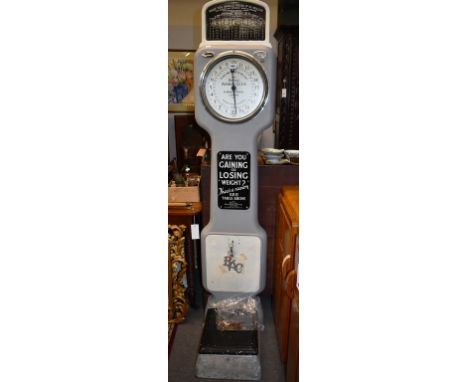 A set of penny scales made by The British Automatic Company Limited with coins to to operate machine.