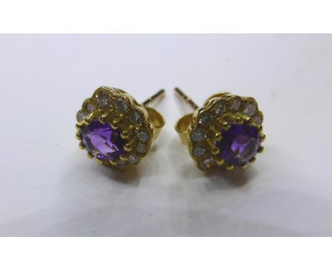 A pair of 18ct yellow gold, amethyst and diamond cluster stud earrings