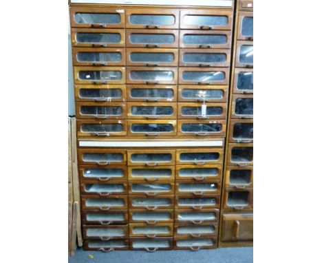 A pair of vintage oak haberdasher's or haberdashery cabinets with glass front drawers (2)