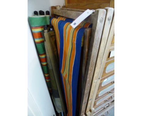 Three vintage deckchairs and two windbreaks.