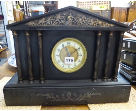 A late Victorian black slate mantle clock of architectural design with classical column decoration.
