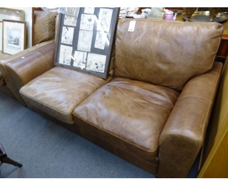 A distressed tan leather two seater sofa