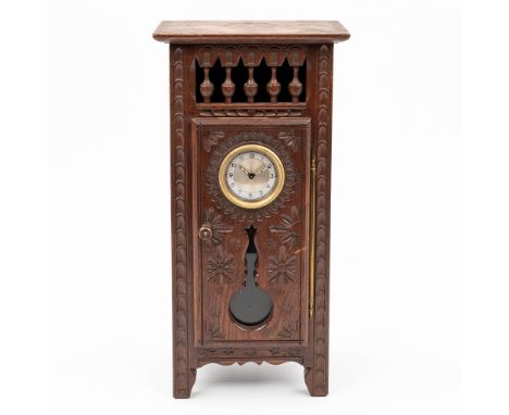 A table clock mounted in a miniature Breton cabinet. Marked Fabrication Francaise - made in France, 19th century. (17,5 x 10,