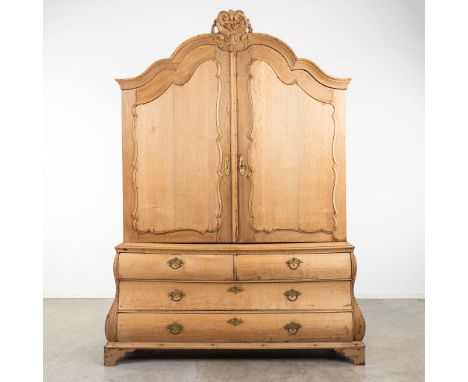 A stripped Dutch cabinet made of oak, 18th century. Condition: Thee is some light wood rot on the back. (60 x 180 x 245 cm)