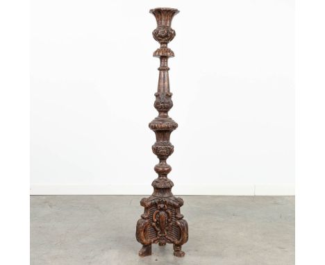 An antique wood sculptured base of a candlestick, around 1800. (102 cm)