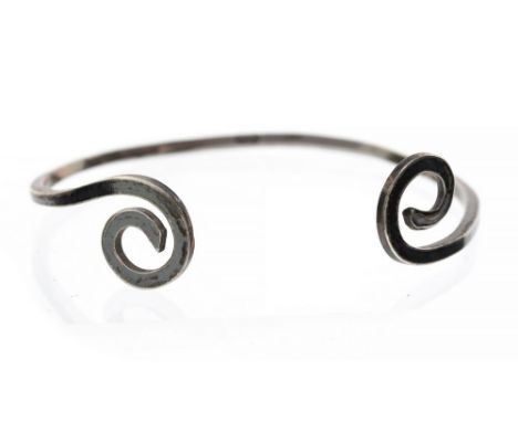 A Modernist silver torque bangle, Celtic spiral ends, marked PD, 5.8cm diameter
