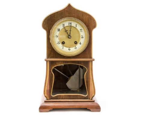 An Edwardian Art Nouveau style beach and mahogany cased eight day mantle clock, stylised ogee tulip form with enamelled chapt