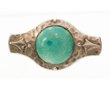 An Arts and Crafts Ruskin and Plantagenet pewter brooch, turquoise ceramic cabouchon within a hand wrought setting with raise