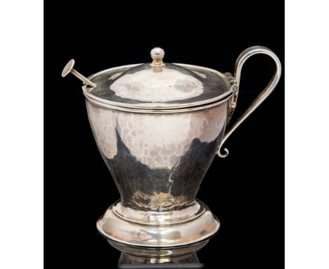 Arthur Stansfield Dixon for the Birmingham Guild of Handicraft, an Arts and Crafts silver mustard pot and spoon, planished fo