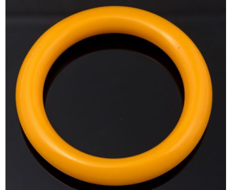 A 1920s amber bakelite bangle, 6.5cm inner diameter, 9cm diameter