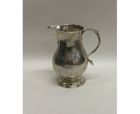 An early Georgian silver sparrow beak pitcher cream jug. London. By IG. Approx. 79 grams. Est. £200 - £300.
