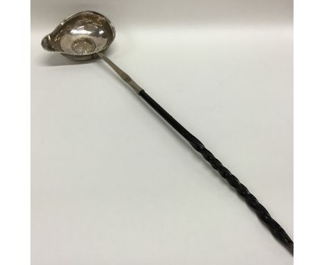 A Georgian silver toddy ladle with whale bone handle. Approx. 45 grams. Est. £20 - £30.