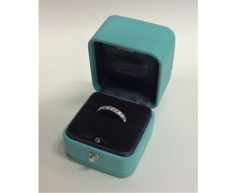 TIFFANY: A good quality heavy platinum full eternity ring contained within a fitted box. Signed to interior. Finger size L. A