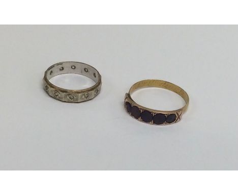 A 9 carat two colour gold eternity ring weighing approx. 2.6 grams together with a gilt mourning ring. Est. £20 - £30.