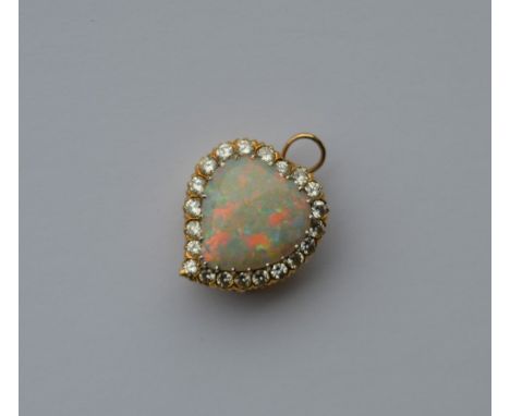 A large opal and diamond brooch in the form of a witch's heart with claw mount. Approx. 7.1 grams. Est. £2500 - £3000.