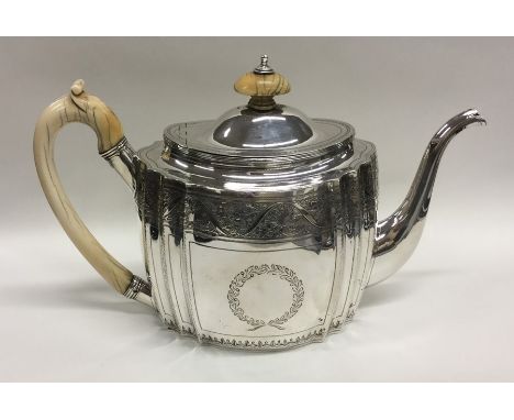 A good quality George III bright cut silver teapot with vacant cartouches to hinged top and ivory handle. London 1818. By SG&