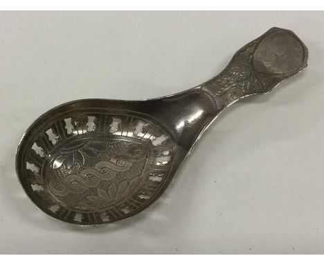 A Georgian silver bright cut caddy spoon with pierced bowl and floral decoration. Approx. 7.6 grams. Est. £40 - £60.