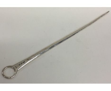 A long Georgian silver meat skewer with ring thumb piece. London. By SM. Approx. 67 grams. Est. £80 - £120.